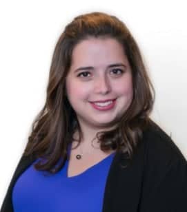 Headshot of Rachael Naphtal. She is a woman with shoulder length brown hair wearing a blue top with a black sweater